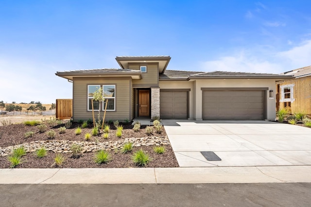 8152 Creek Vw, Friant, CA 93626 - prairie-style house featuring a garage, driveway, and a tile roof