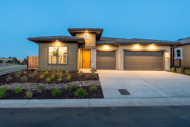 8152 Creek Vw, Friant, CA 93626 - prairie-style house featuring an attached garage, concrete driveway, and a tile roof