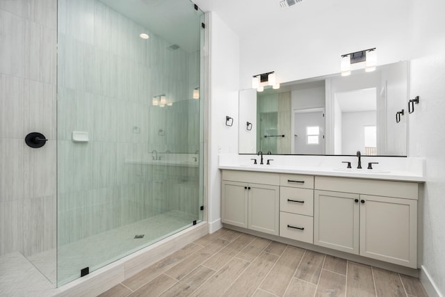 8152 Creek Vw, Friant, CA 93626 - bathroom featuring a tile shower, double vanity, and wood finish floors