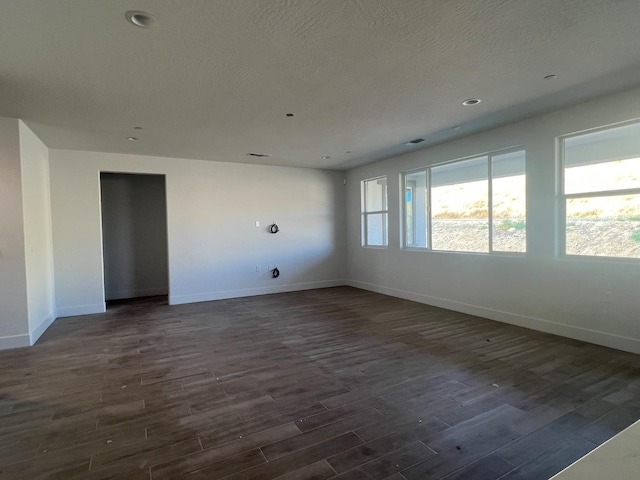 8131 Creek Vw, Friant, CA 93626 - empty room with baseboards, dark wood-type flooring, and a textured ceiling