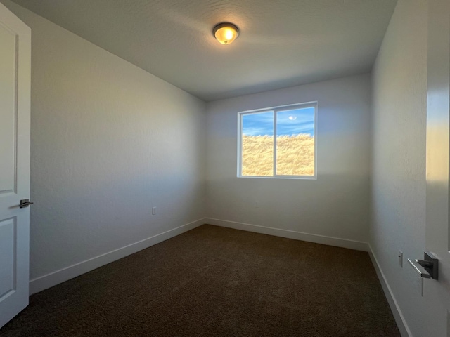 8131 Creek Vw, Friant, CA 93626 - spare room featuring dark colored carpet and baseboards