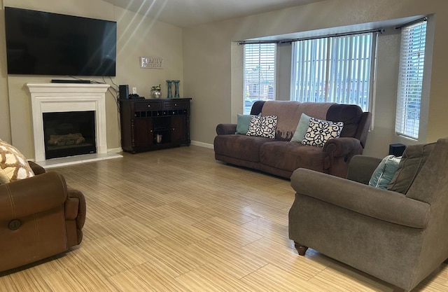 1561 Josephine Ct, Madera, CA 93638 - living area with a fireplace with raised hearth and wood finished floors
