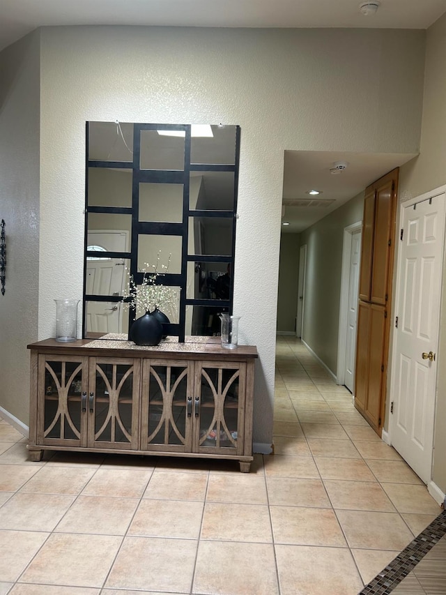 1561 Josephine Ct, Madera, CA 93638 - hall with light tile patterned flooring, a textured wall, and baseboards