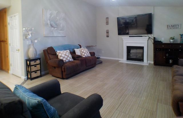 1561 Josephine Ct, Madera, CA 93638 - living area featuring a glass covered fireplace, baseboards, and a ceiling fan