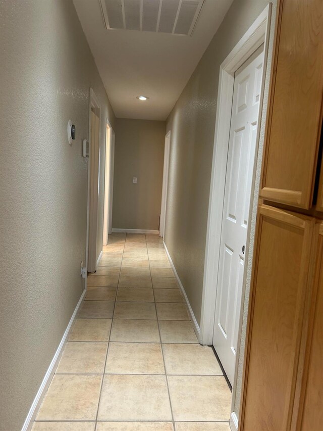 1561 Josephine Ct, Madera, CA 93638 - hallway with light tile patterned floors, baseboards, and a textured wall