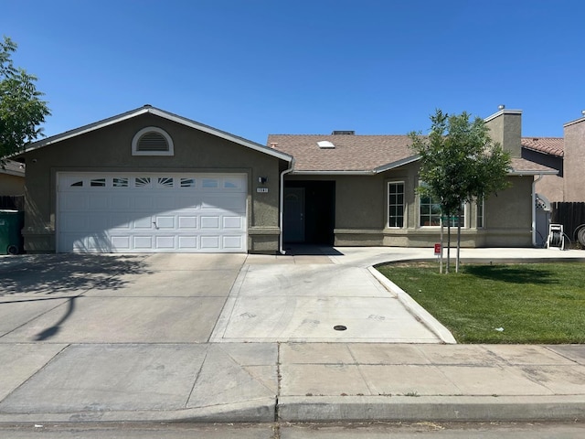 1561 Josephine Ct, Madera, CA 93638 - ranch-style house with stucco siding, concrete driveway, a garage, a chimney, and a front yard