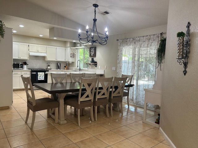 1561 Josephine Ct, Madera, CA 93638 - dining room with a chandelier, light tile patterned floors, recessed lighting, a textured wall, and baseboards