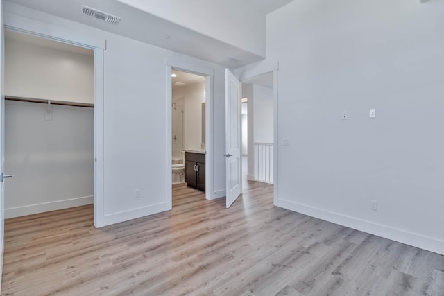 1734 Lester Ave, Clovis, CA 93619 - unfurnished bedroom featuring light wood finished floors, baseboards, a closet, and a spacious closet