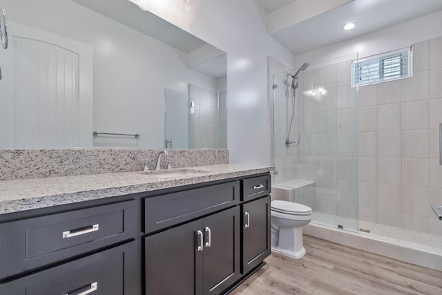 1734 Lester Ave, Clovis, CA 93619 - bathroom with toilet, vanity, tiled shower, and wood finished floors