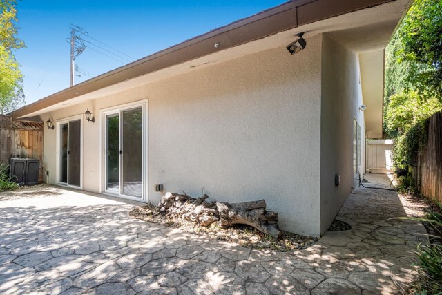 1785 W Calimyrna Ave Unit A, Fresno, CA 93711 - back of house with stucco siding and a patio