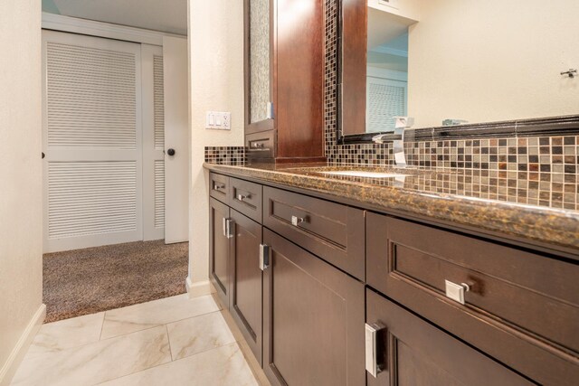 1785 W Calimyrna Ave Unit A, Fresno, CA 93711 - full bathroom with vanity, decorative backsplash, and a closet