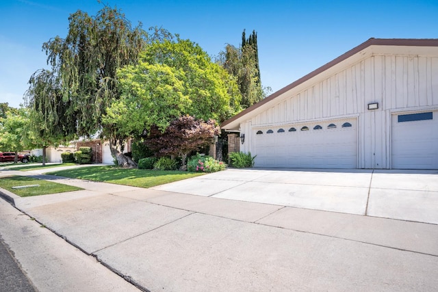 1785 W Calimyrna Ave Unit A, Fresno, CA 93711 - view of front of home featuring board and batten siding and a front lawn