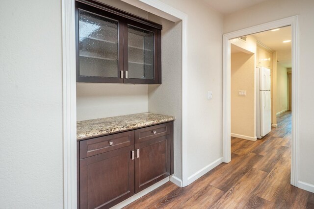 1785 W Calimyrna Ave Unit A, Fresno, CA 93711 - bar featuring freestanding refrigerator, dark wood-style flooring, and baseboards