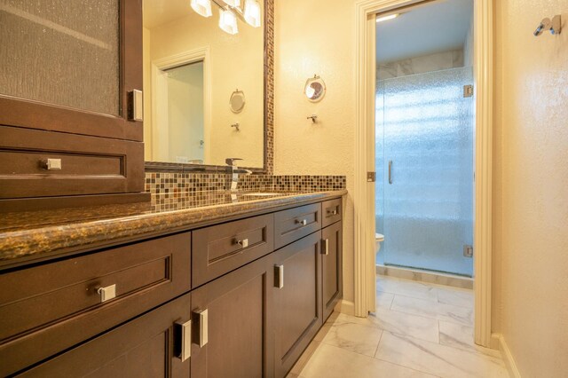 1785 W Calimyrna Ave Unit A, Fresno, CA 93711 - full bathroom with toilet, marble finish flooring, vanity, a stall shower, and decorative backsplash