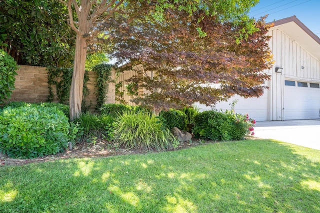 1785 W Calimyrna Ave Unit A, Fresno, CA 93711 - view of grassy yard featuring concrete driveway and a garage