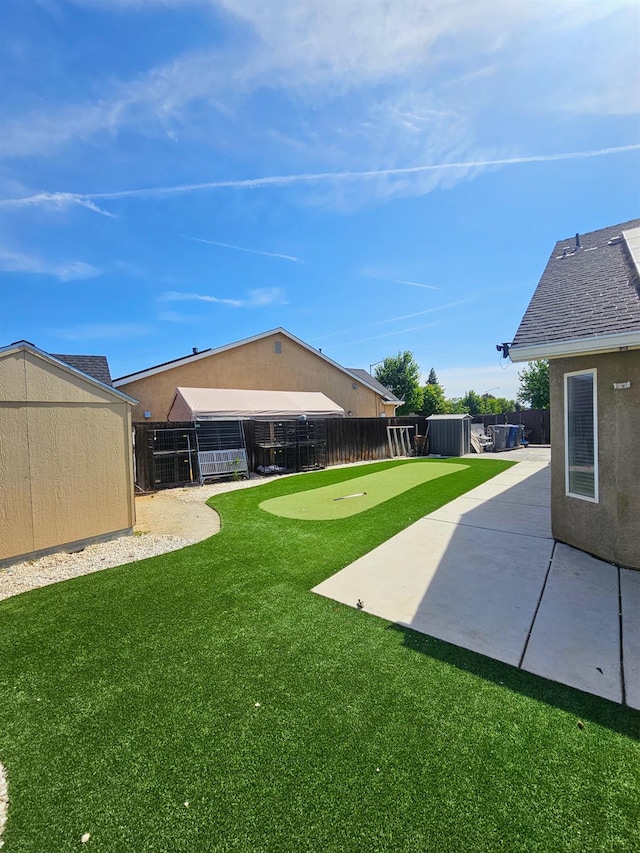 5453 N San Clemente Ave, Fresno, CA 93723 - view of yard featuring a putting area, a patio area, and central AC