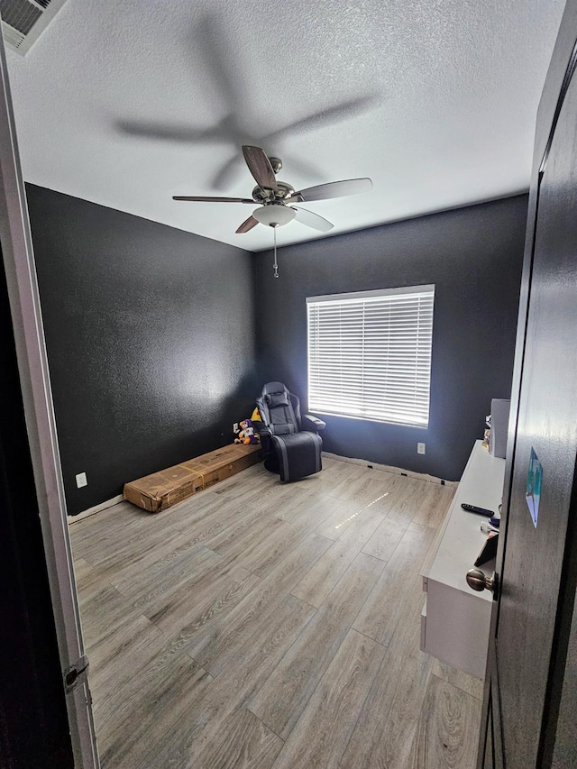 5453 N San Clemente Ave, Fresno, CA 93723 - unfurnished room with wood finished floors, ceiling fan, and a textured ceiling