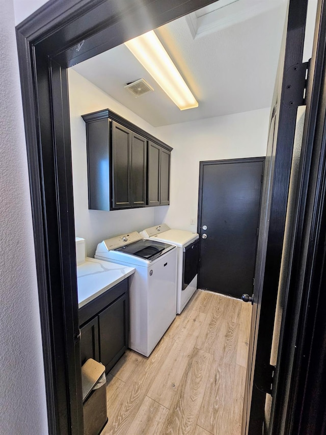 5453 N San Clemente Ave, Fresno, CA 93723 - washroom with light wood finished floors, cabinet space, and washing machine and clothes dryer