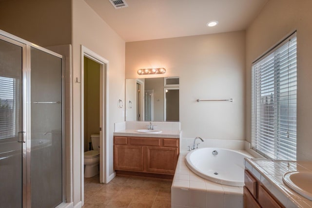 5453 N San Clemente Ave, Fresno, CA 93723 - bathroom featuring vanity, a garden tub, a stall shower, and toilet