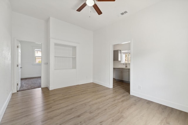 630 N Roosevelt Ave, Fresno, CA 93728 - unfurnished room with a ceiling fan, light wood-style floors, baseboards, and a sink