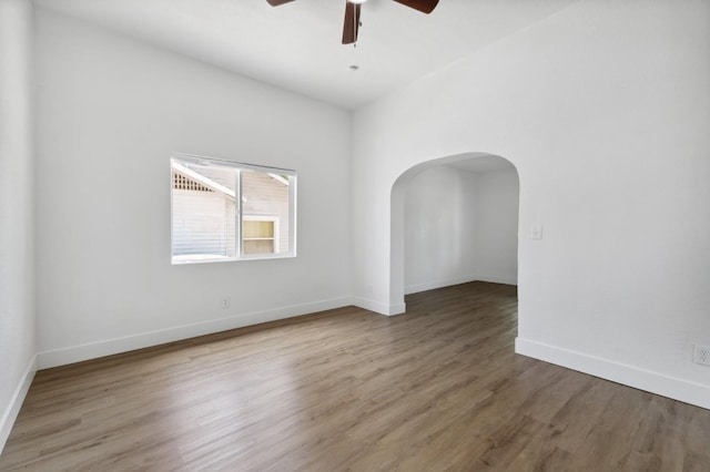 630 N Roosevelt Ave, Fresno, CA 93728 - unfurnished room featuring arched walkways, ceiling fan, wood finished floors, and baseboards