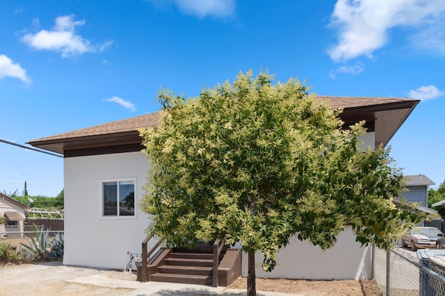 630 N Roosevelt Ave, Fresno, CA 93728 - back of house with roof with shingles and stucco siding