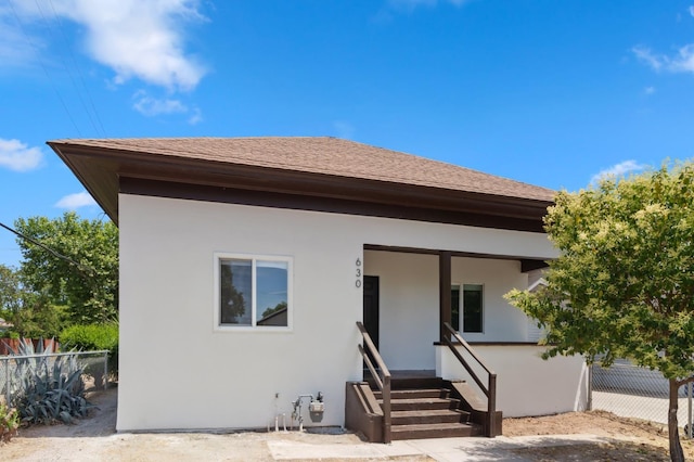 630 N Roosevelt Ave, Fresno, CA 93728 - view of front of house with stucco siding and a shingled roof