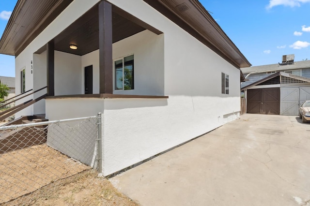 630 N Roosevelt Ave, Fresno, CA 93728 - view of side of property featuring stucco siding, a patio, and an outdoor structure