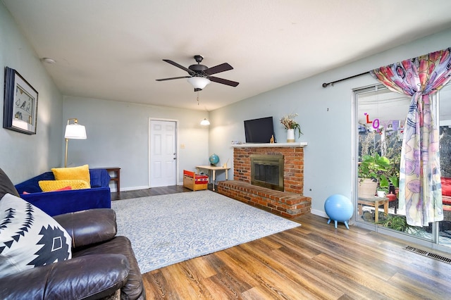 200 Autumn Rd, Madera, CA 93637 - living room featuring wood finished floors, a brick fireplace, ceiling fan, and baseboards