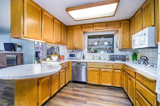 200 Autumn Rd, Madera, CA 93637 - kitchen with white microwave, dishwasher, tasteful backsplash, and a peninsula