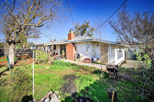 200 Autumn Rd, Madera, CA 93637 - rear view of house with a chimney, a patio, and brick siding