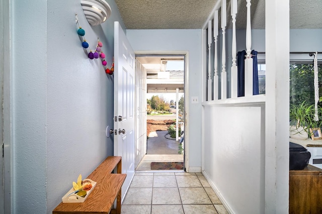 200 Autumn Rd, Madera, CA 93637 - entryway with a textured ceiling, baseboards, and light tile patterned flooring
