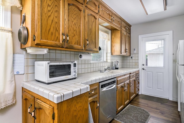 2994 E Cornell Ave, Fresno, CA 93703 - kitchen featuring stainless steel dishwasher, a sink, dark wood-style flooring, decorative backsplash, and brown cabinets