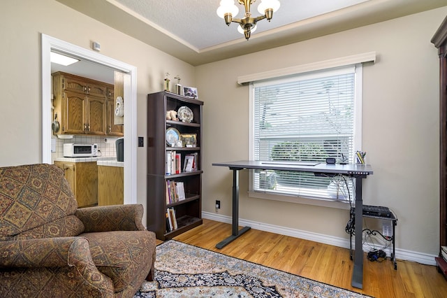2994 E Cornell Ave, Fresno, CA 93703 - office with light wood-style flooring, a chandelier, and baseboards