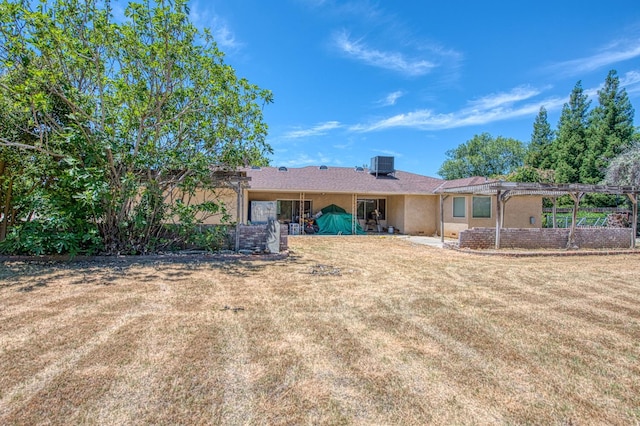 7820 N Fancher Rd, Clovis, CA 93619 - rear view of house with central AC, a pergola, a yard, and stucco siding