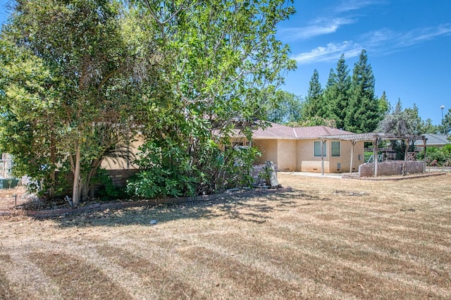 7820 N Fancher Rd, Clovis, CA 93619 - view of front facade featuring a pergola, stucco siding, and a front lawn