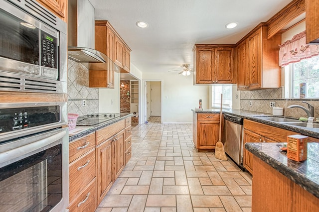 7820 N Fancher Rd, Clovis, CA 93619 - kitchen with stainless steel appliances, wall chimney exhaust hood, a ceiling fan, backsplash, and brown cabinetry
