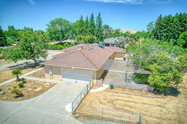 7820 N Fancher Rd, Clovis, CA 93619 - view of front of property with driveway, a garage, stucco siding, and central AC unit