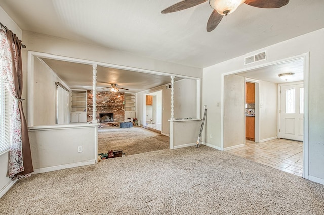 7820 N Fancher Rd, Clovis, CA 93619 - unfurnished living room featuring a ceiling fan, light colored carpet, a fireplace, and baseboards