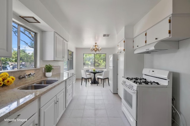 4824 E Brown Ave, Fresno, CA 93703 - kitchen featuring white appliances, a sink, healthy amount of natural light, and white cabinetry