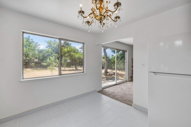 4824 E Brown Ave, Fresno, CA 93703 - unfurnished dining area with a chandelier, baseboards, and light carpet