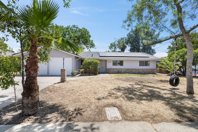 4824 E Brown Ave, Fresno, CA 93703 - single story home featuring driveway, a garage, solar panels, and brick siding