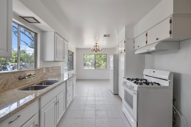 4824 E Brown Ave, Fresno, CA 93703 - kitchen featuring white appliances, a sink, white cabinetry, a chandelier, and light stone countertops