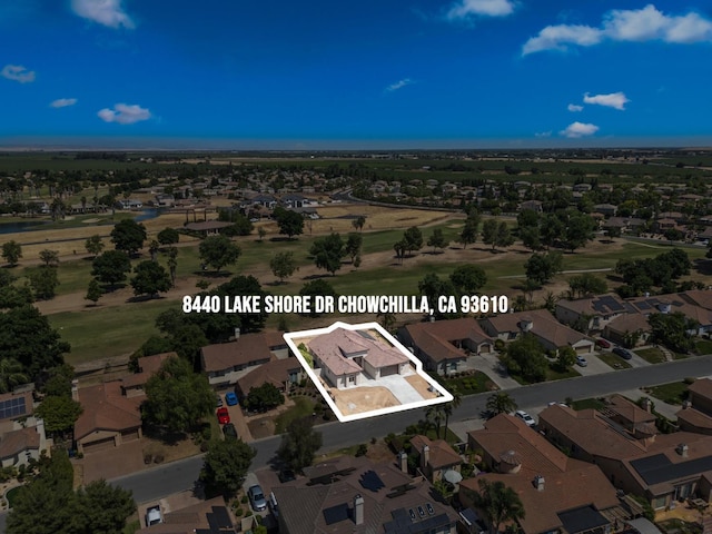 8440 Lake Shore Dr, Chowchilla, CA 93610 - aerial view of property and surrounding area with property parcel outlined and nearby suburban area