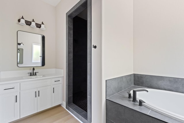 8440 Lake Shore Dr, Chowchilla, CA 93610 - bathroom with a bath, vanity, tiled shower, and wood finished floors