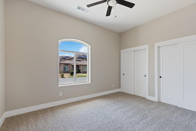 8440 Lake Shore Dr, Chowchilla, CA 93610 - unfurnished bedroom with carpet flooring, two closets, baseboards, and a ceiling fan