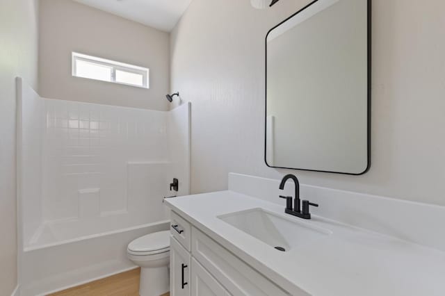 8440 Lake Shore Dr, Chowchilla, CA 93610 - full bathroom with vanity, toilet, wood finished floors, and tub / shower combination