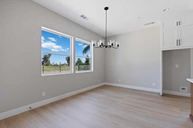 8440 Lake Shore Dr, Chowchilla, CA 93610 - empty room with a chandelier, light wood finished floors, and baseboards