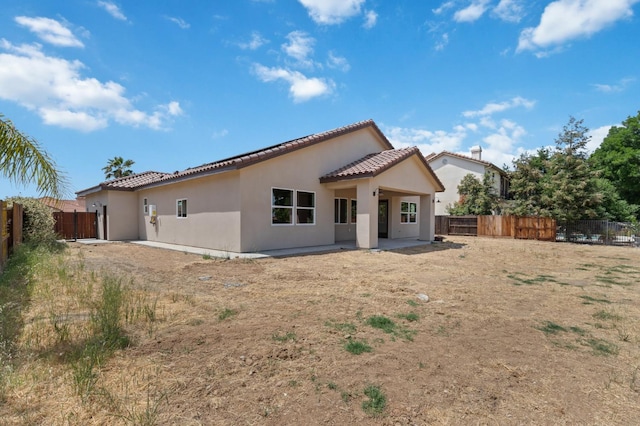 8440 Lake Shore Dr, Chowchilla, CA 93610 - rear view of property with a tiled roof, stucco siding, and a patio area