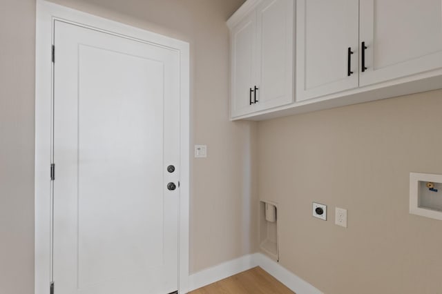 8440 Lake Shore Dr, Chowchilla, CA 93610 - washroom featuring hookup for an electric dryer, cabinet space, hookup for a washing machine, baseboards, and light wood-type flooring
